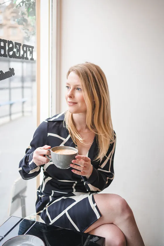Madison Potter, founder of Mad Social, thoughtful with coffee in Edinburgh